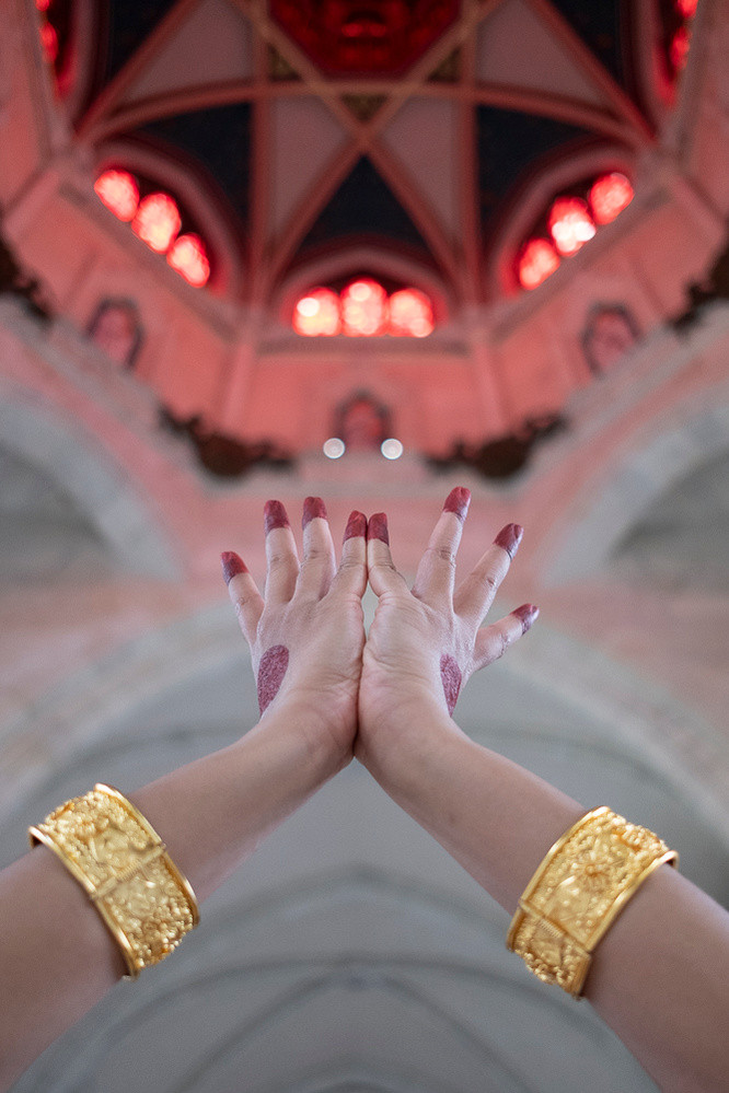 Hands of woman wearing gold bangles