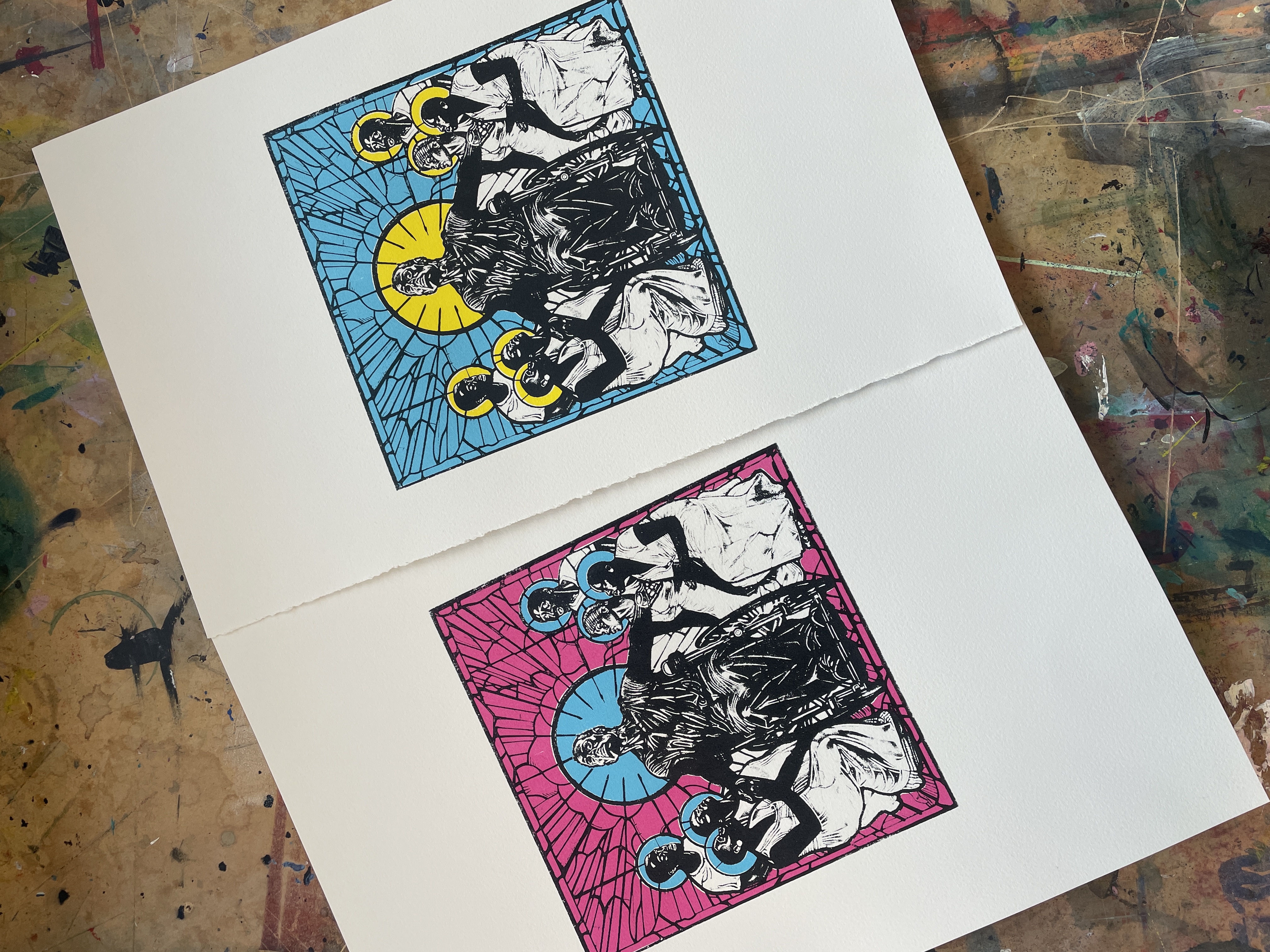 Two screenprints produced by Christopher Samuel at Arthouse Print Studio. They are different colourways of the same image - a black man with a halo of light sits in a wheelchair, surrounded by people reaching out to touch him.